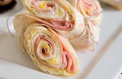 Fried egg and ham wraps with roast tomatoes and mushrooms