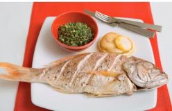 Baked whole fish with lemon, almond and herb stuffing