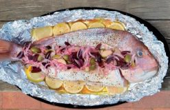 Whole baked snapper with lemon and caper berries